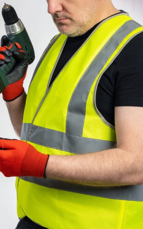 Man repairman with phone. Cropped electrician holds screwdriver. Engineer stands near power panel. Repairman calls customer. Man foreman near electrical equipment. Electrician dressed in yellow vest Man repairman with phone. Cropped electrician holds screwdriver. Engineer stands near power panel. Repairman calls customer. Man foreman near electrical equipment. Electrician dressed in yellow vest
